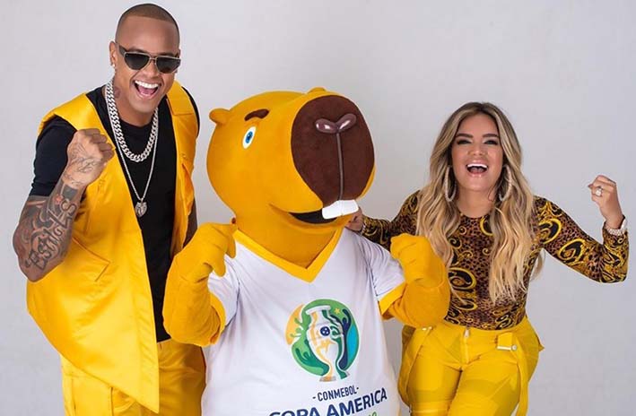 Karol G , Leo Santana y la mascota de la Copa América Zizito.